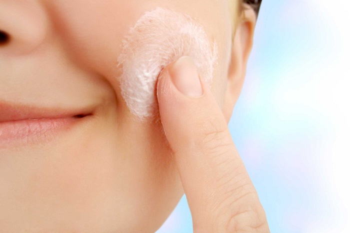 woman moisturizing her skin