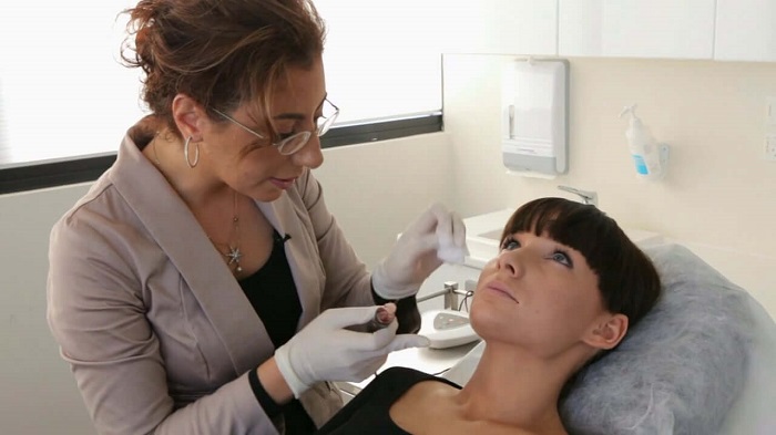 dermatologist and her patient during a treatment session