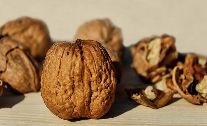whole and half walnuts on a table
