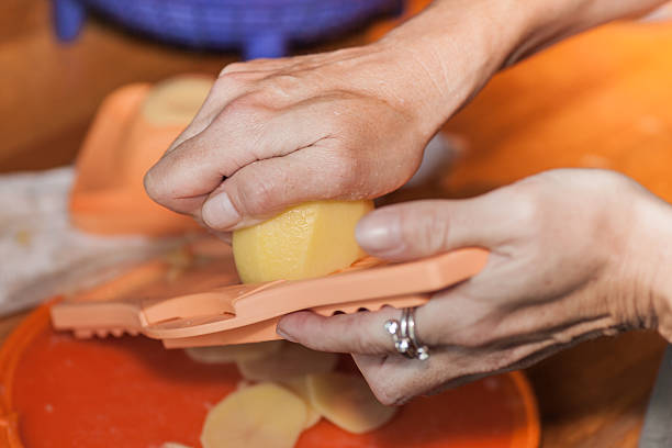 Woman hands working on a potato grater
